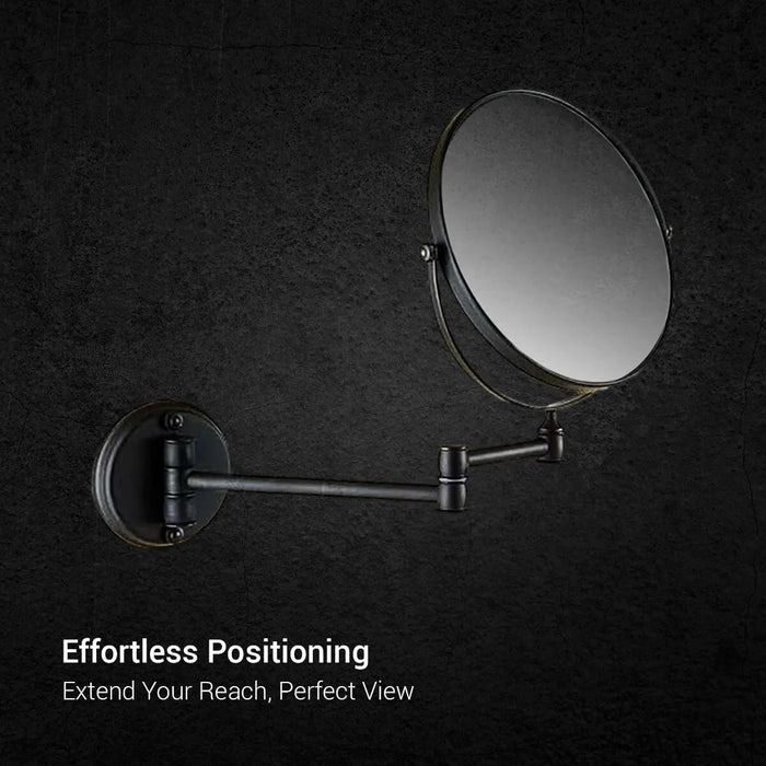Round 3x magnification shaving mirror with rose gold rim and adjustable pivot arms on dark grey marble - Glazonoid