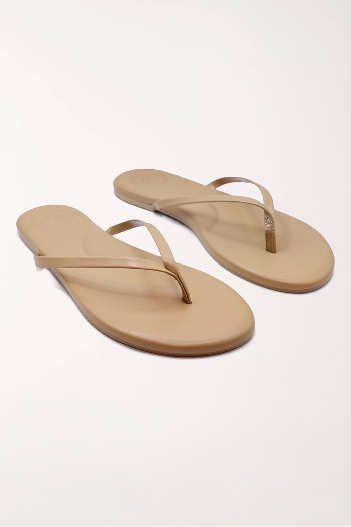 Pair of brown flip-flops on a white background