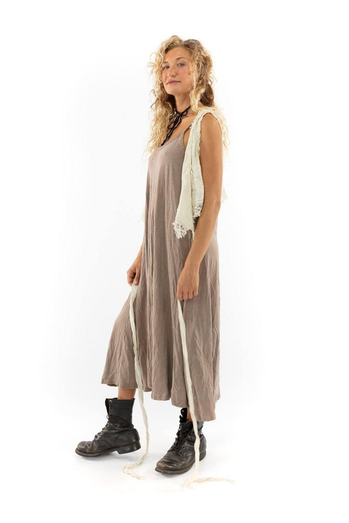 Woman in Magnolia Pearl clay dress, artisan vintage style, whimsical design, lace vest, boots