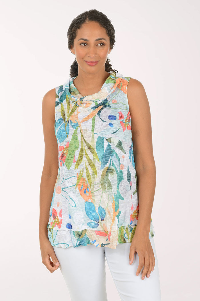 Woman wearing a colorful floral sleeveless top against a white background