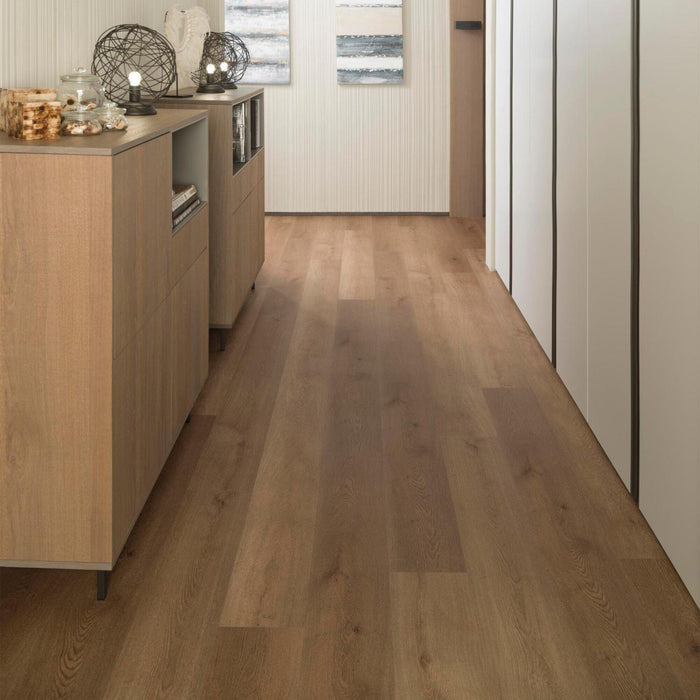 Hallway with wood effect luxury vinyl flooring and cabinets on either side.