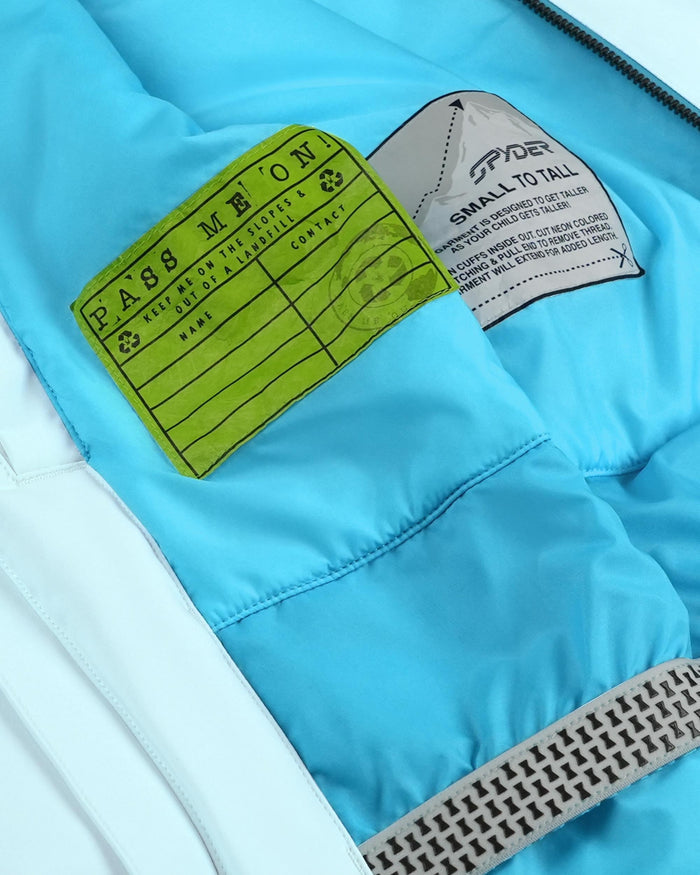 Close-up of a blue jacket with a green label and gray text on a white background