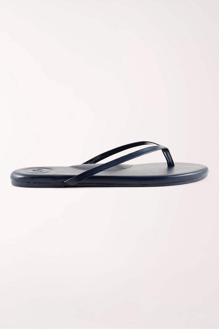 Pair of navy blue flip-flops on a white background