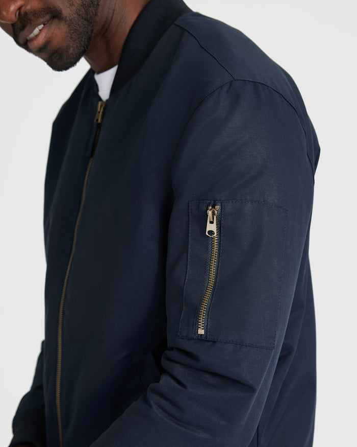 Navy Bomber Jacket with brass zipper and sleeve pocket.