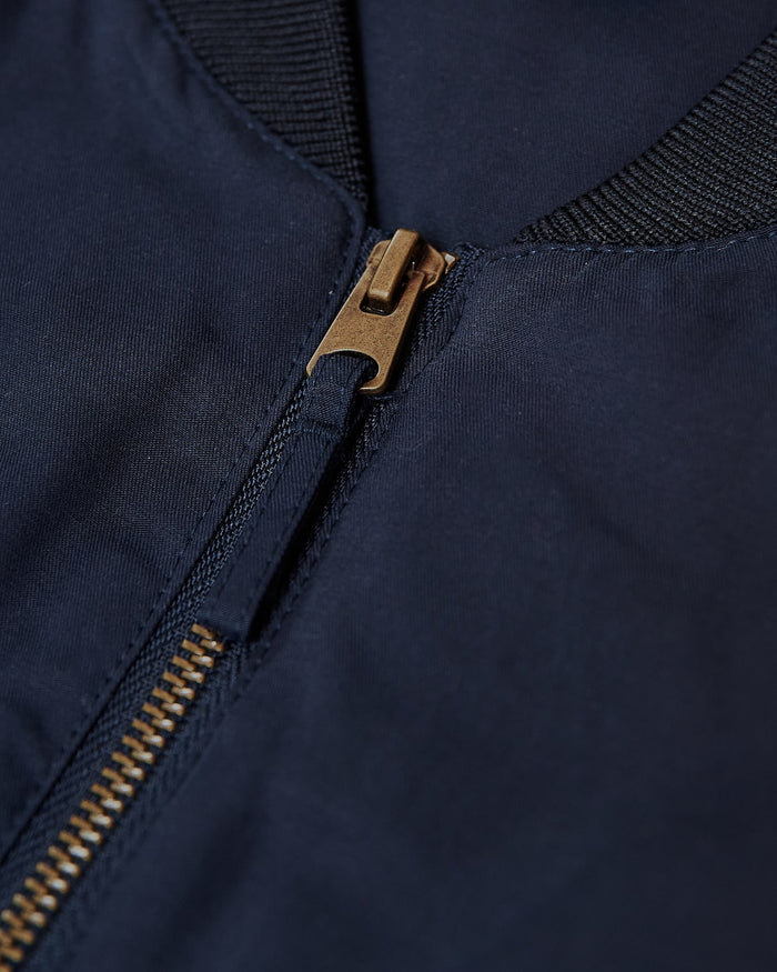 Navy Bomber Jacket with brass zipper and ribbed collar.