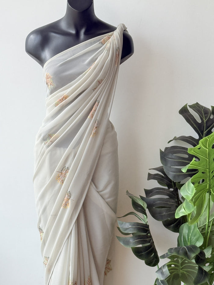 Pastel green maple leaf emb georgette saree