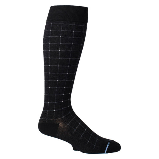 Knee-high black compression sock with a white pin dot grid pattern and a solid black cuff.