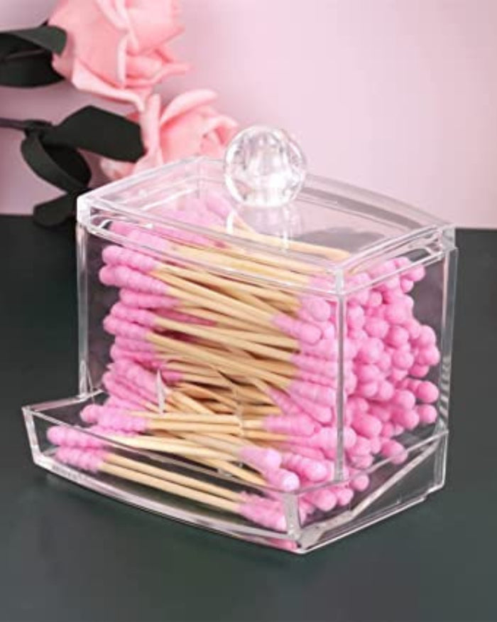 Clear acrylic swab and pad holder filled with cotton swabs and foam buds