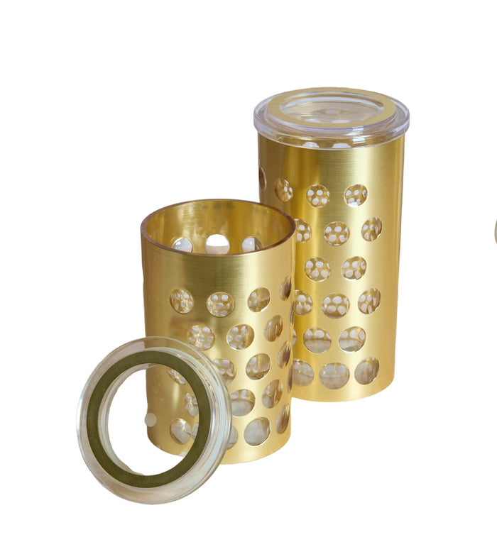 Gold airtight storage jar set with clear lids; one lid shown open on counter.