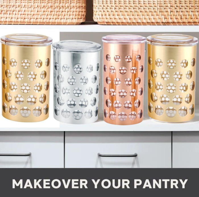 Assorted polka dot airtight storage jars in gold, silver, and rose with clear lids.