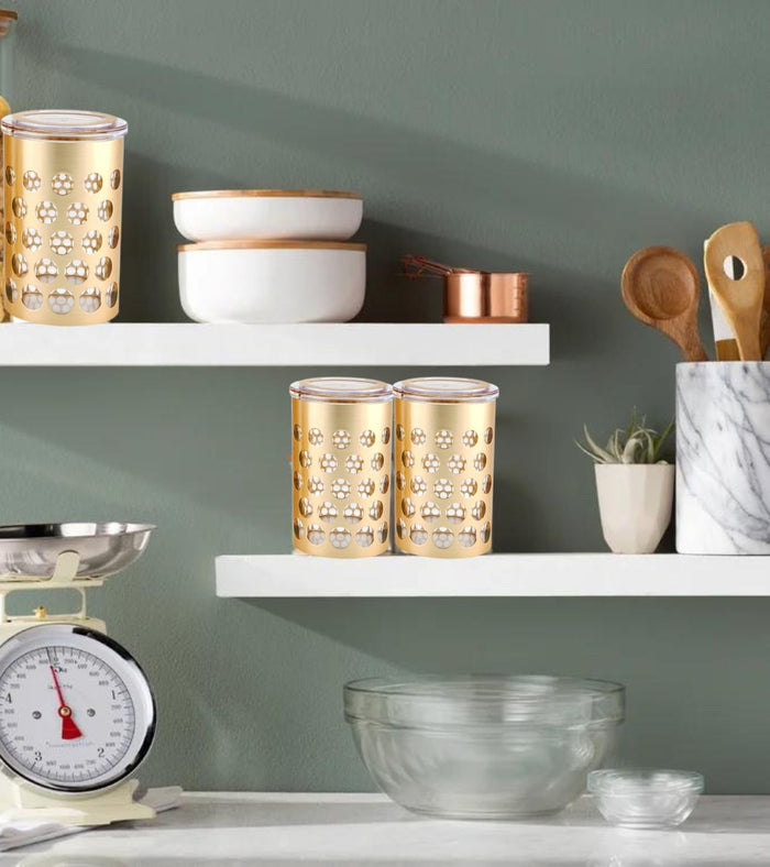 Pair of gold and silver airtight storage jars with clear lids and polka dot design.