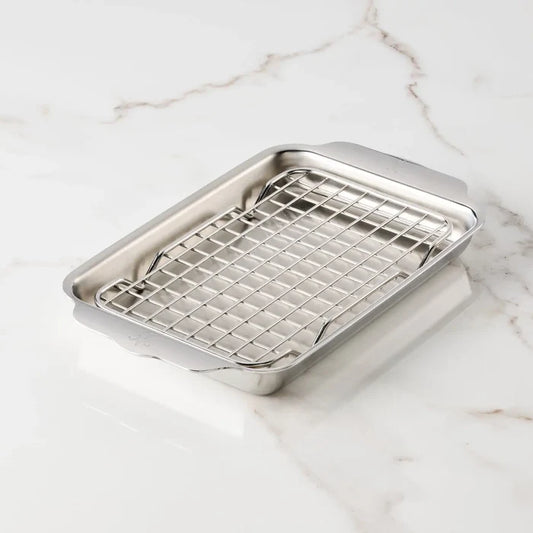 Stainless steel pan with a rack on a marble surface