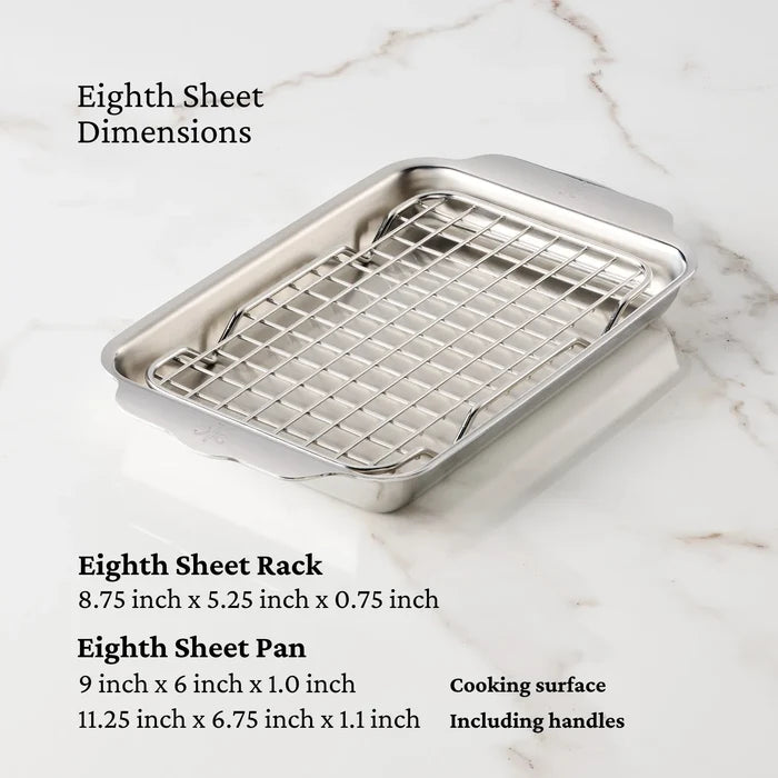 Stainless steel sheet pan with rack on a marble surface