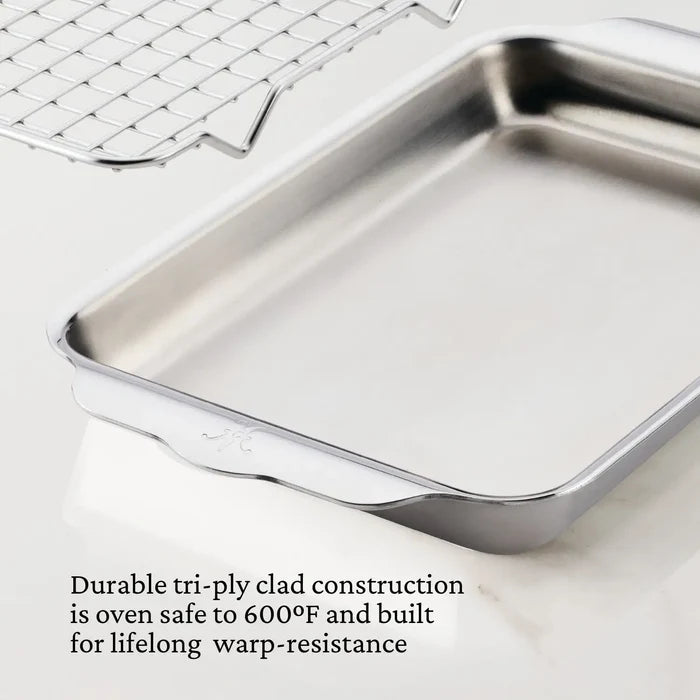 Stainless steel baking pan with oven rack on a white background