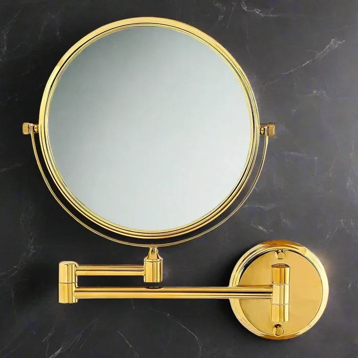 Round 3x magnification shaving mirror with rose gold rim and adjustable pivot arms on dark grey marble - Glazonoid