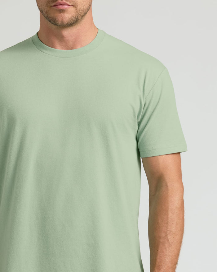 Man wearing a light green t-shirt against a plain background