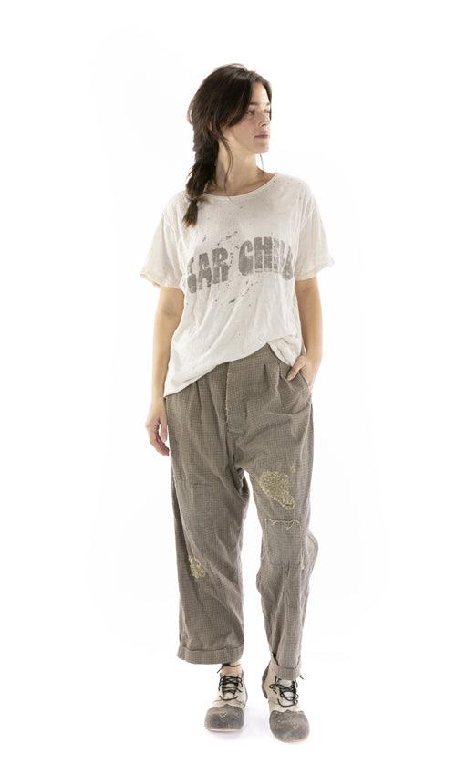 Woman in Magnolia Pearl vintage artisan t-shirt and patched pants, whimsical boho style