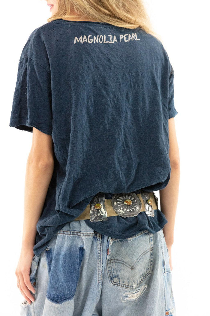 Magnolia Pearl artisan t-shirt with whimsical vintage style, patchwork jeans, and concho belt