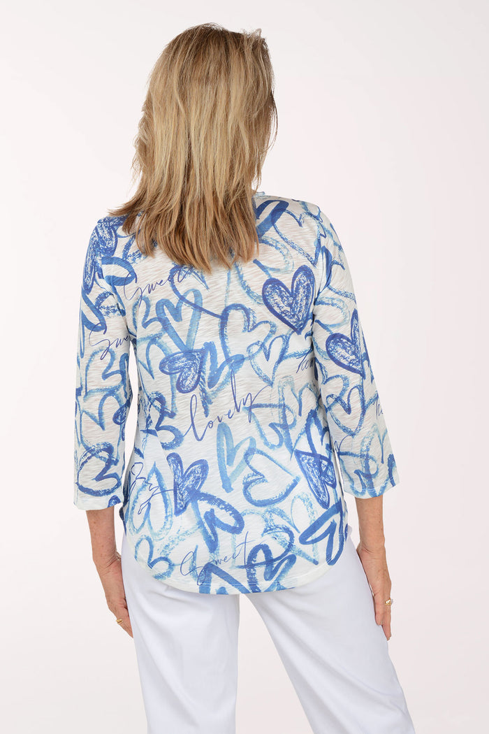 Woman wearing a blue and white patterned top on a white background