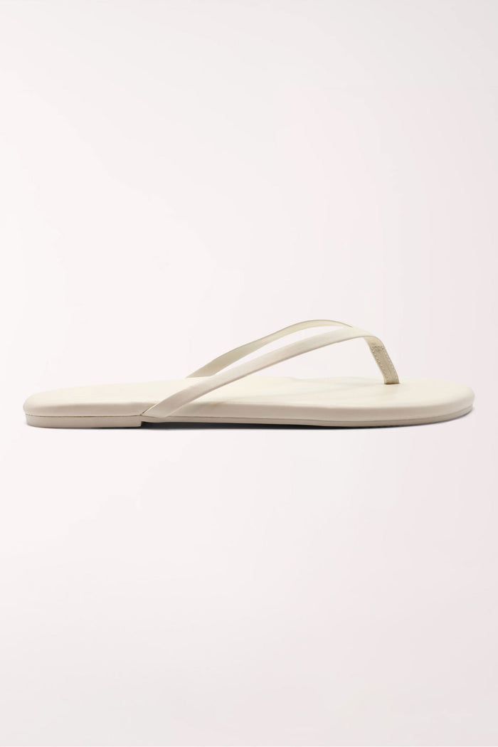 Pair of white flip-flops on a light gray background