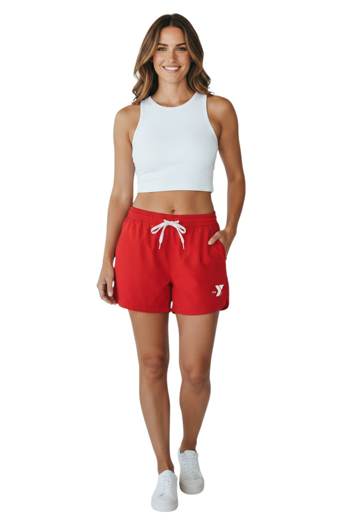 The Lifeguard Store red polyester YMCA roll shorts with elastic waistband, drawstring, and two front pockets. Quick-dry fabric.